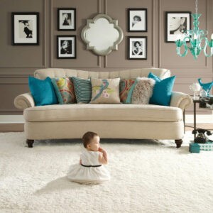 Cute baby sitting on bright carpet | Carpet Exchange