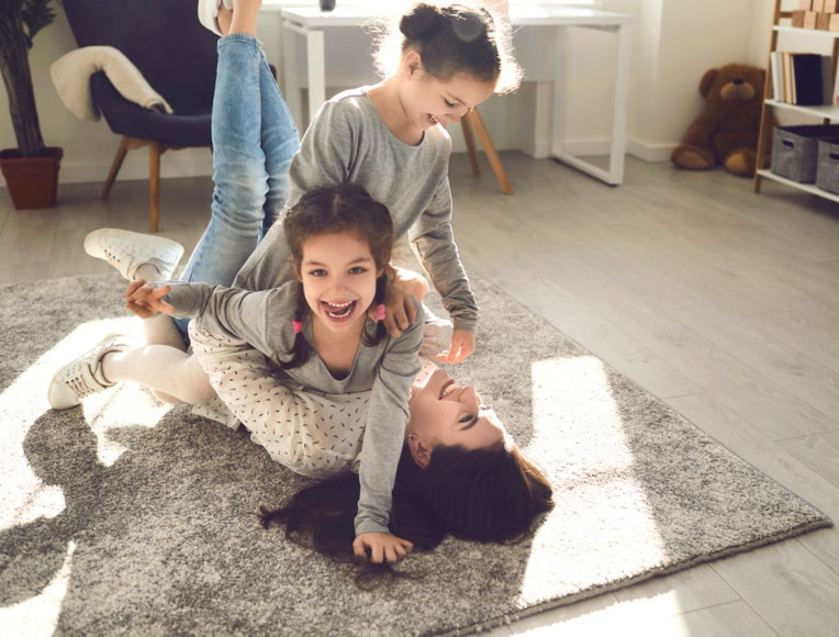 Happy family on custom rug | Carpet Exchange