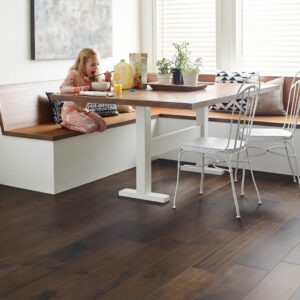 kid sitting at breakfast nook with Hardwood flooring | Carpet Exchange